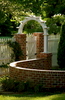 Serpentine brick wall establishes connecting garden rooms in this Williamsburg inspired garden