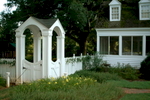 In front, curved brick wing walls expand and emphasize a welcoming front door. Several 6'x6' basketweave brick landings embellish pathway corners while a richly-detailed gazebo transports the farmhouse architecture into the garden. The four-sided gazebo acts as a signature focal and transition point to elegantly enclose the children's play area beyond. Reminiscent of the home's farming heritage, plants include rosemary, germander and thyme paired with a fresh composition of traditional favorites such as boxwood, gardenia, camellia and daylily.