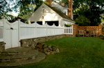 Traditional picket fence atop vintage stone knee wall