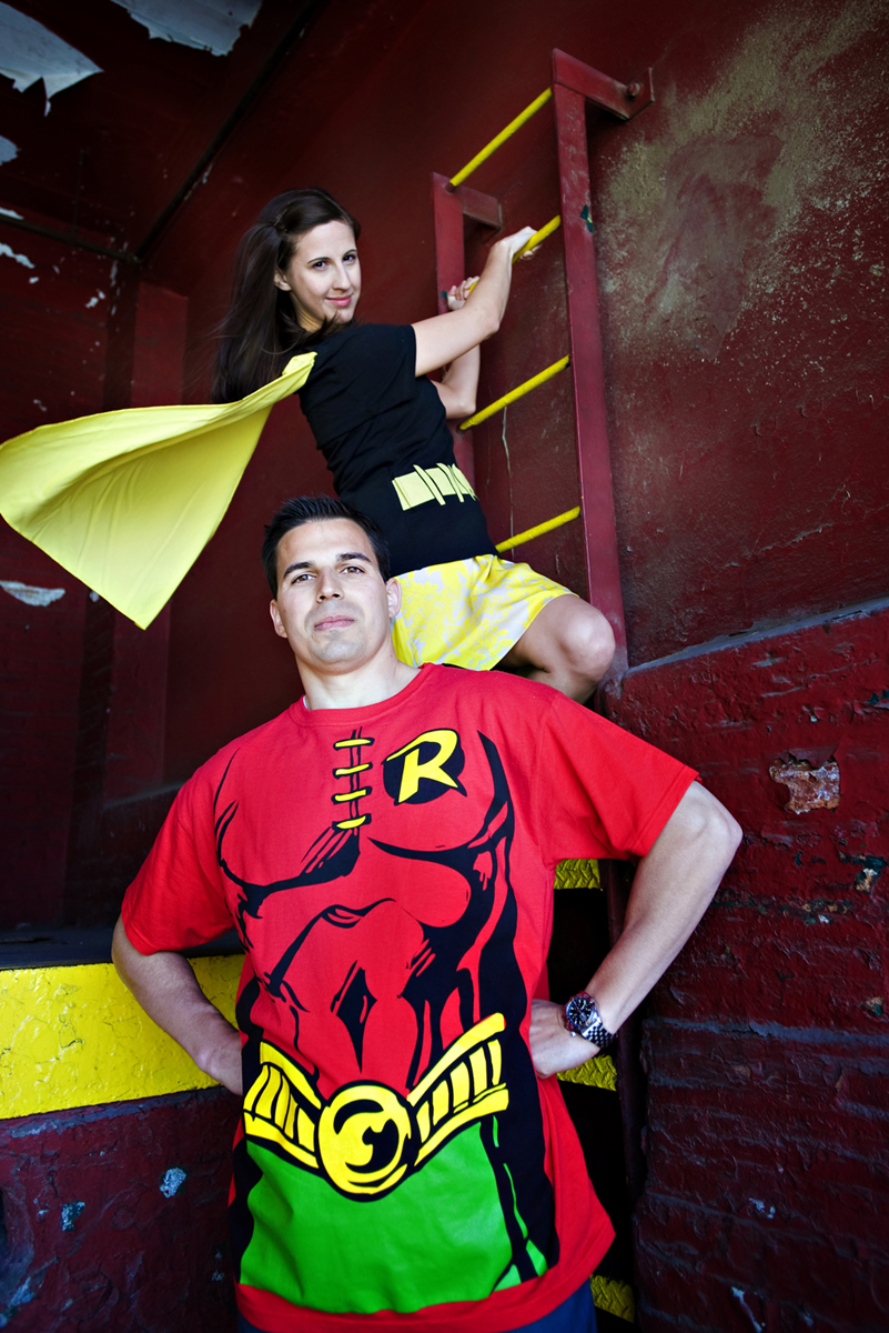 engaged couple dressed as superheros batman and robin during their creative engagement session. Hoboken wedding photographers