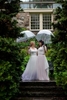 Two brides with umbrellas at Reeves-Reed Arboretum