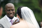 groom wipes away tear as bride cries during wedding ceremony at The Water Witch Club at Monmouth Hills. Jersey Shore wedding photographers