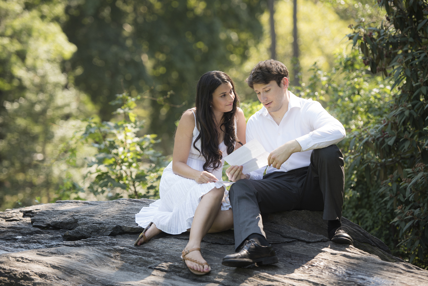 Couple reads love notes during Central Park engagement session
