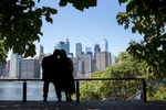 couple against NYC skyline during their engagement session. NYC wedding photographer