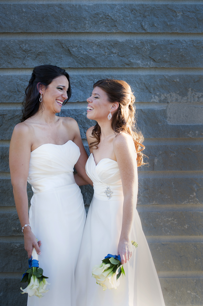 brides laughing together on their wedding day. Lesbian wedding. NYC wedding photographers