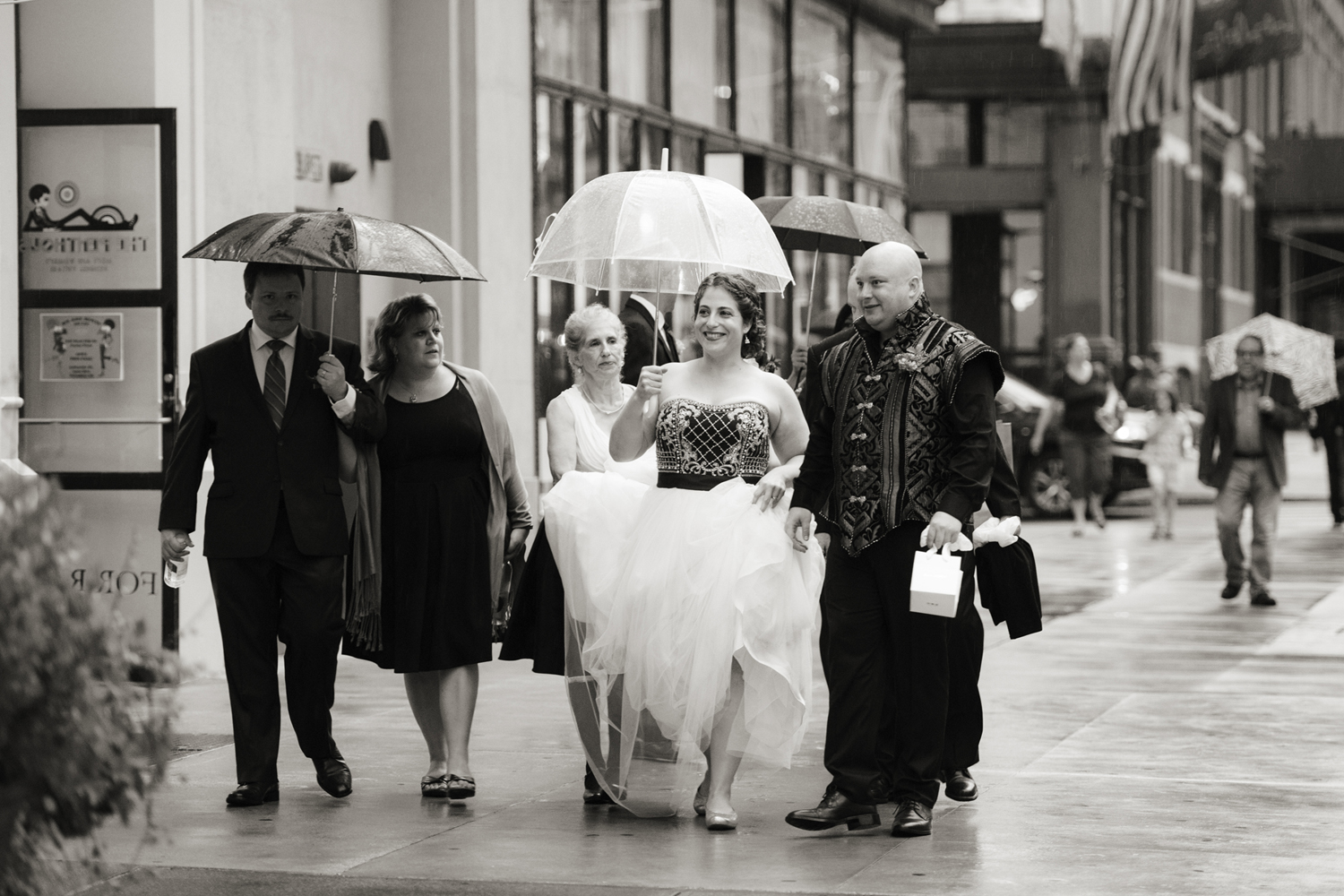 bride walking under umbrella on her wedding day wedding in New York City