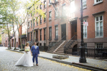 bride and groom walking on cobbestone street in west village, NYC on their wedding day. NYC wedding photographers