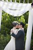 bride and groom kissing at conclusion of wedding ceremony at Queens Botanical Garden. NYC wedding photographers