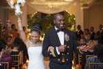 black bride and groom celebrate after their are wed at their ceremony at Manhattan Penthouse. Groom is in Navy uniform.