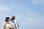 portrait of bride and groom against blue sky at The Water Witch Club at Monmouth Hills on their wedding day. Jersey Shore wedding photos