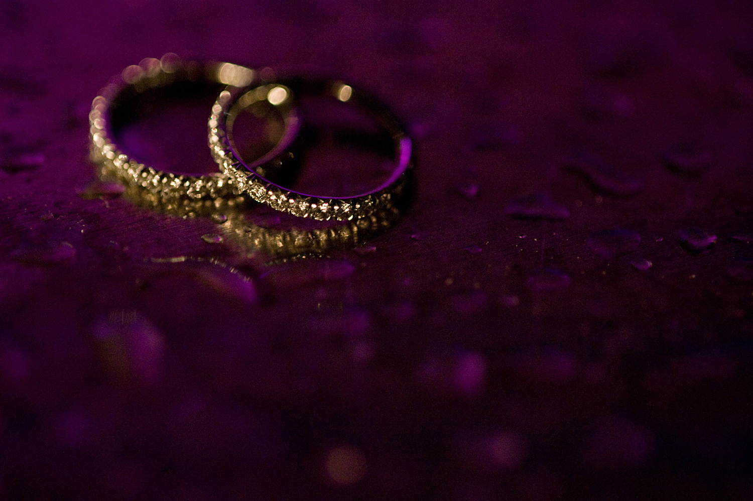 Creative ring shot of wedding rings at Liberty House. NYC wedding photographers