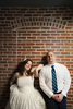Portrait of bride and groom against brick wall at BLDG 92, Brooklyn Navy Yard. NYC wedding photographers