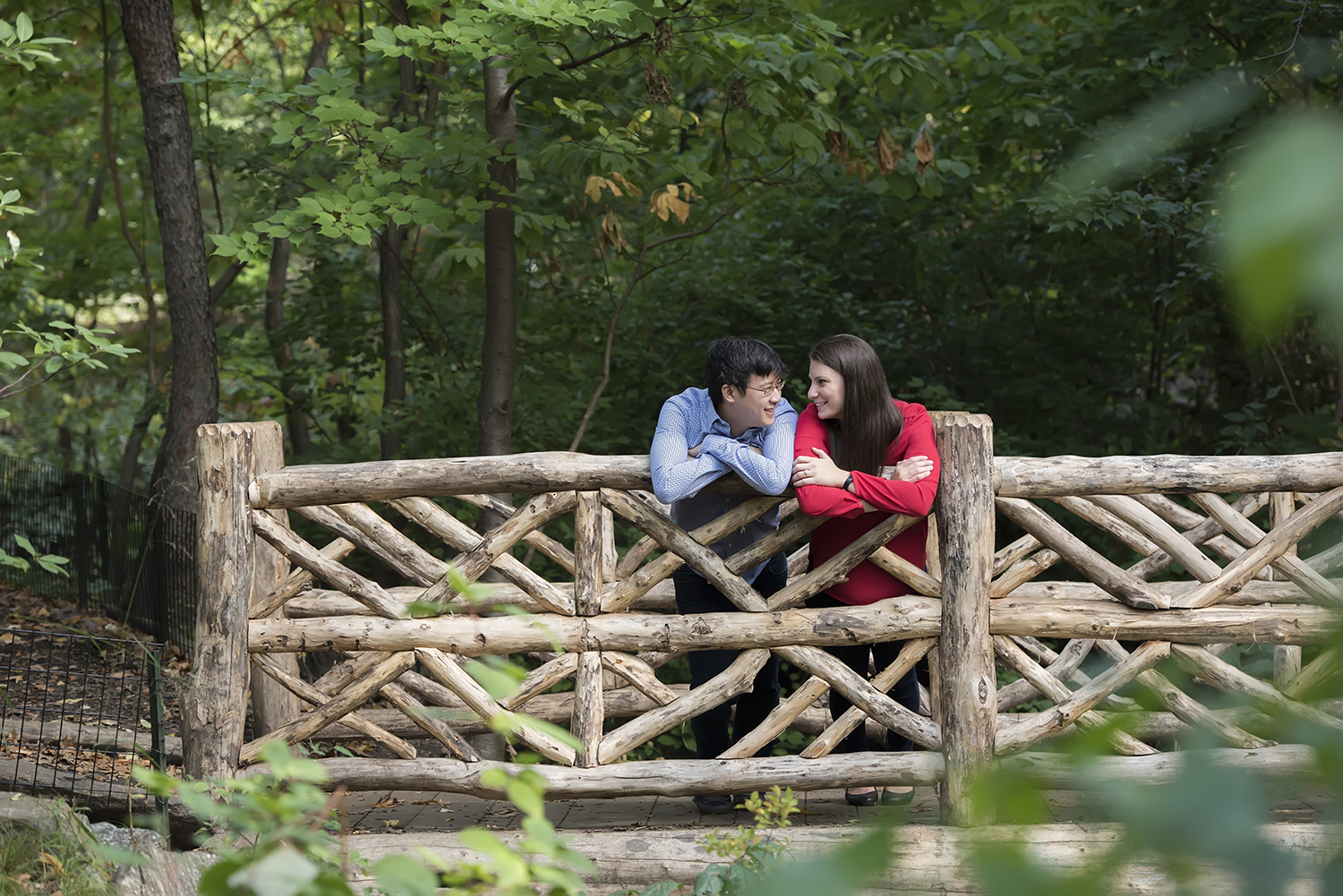 Couple on bridge during Central Park engagement session