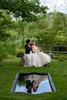 Brides on their wedding day in reflection pool at Crossed Keys Estate. LGBTQ wedding photographer