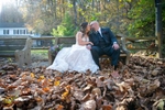 bride and groom kissing amongst the fall leaves
