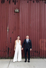 bride and groom against red wall in Hoboken before their wedding celebration at Kolo Klub