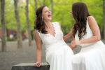 brides laugh during their portraits in Hoboken on their wedding day. LGBTQ Hoboken wedding photographer