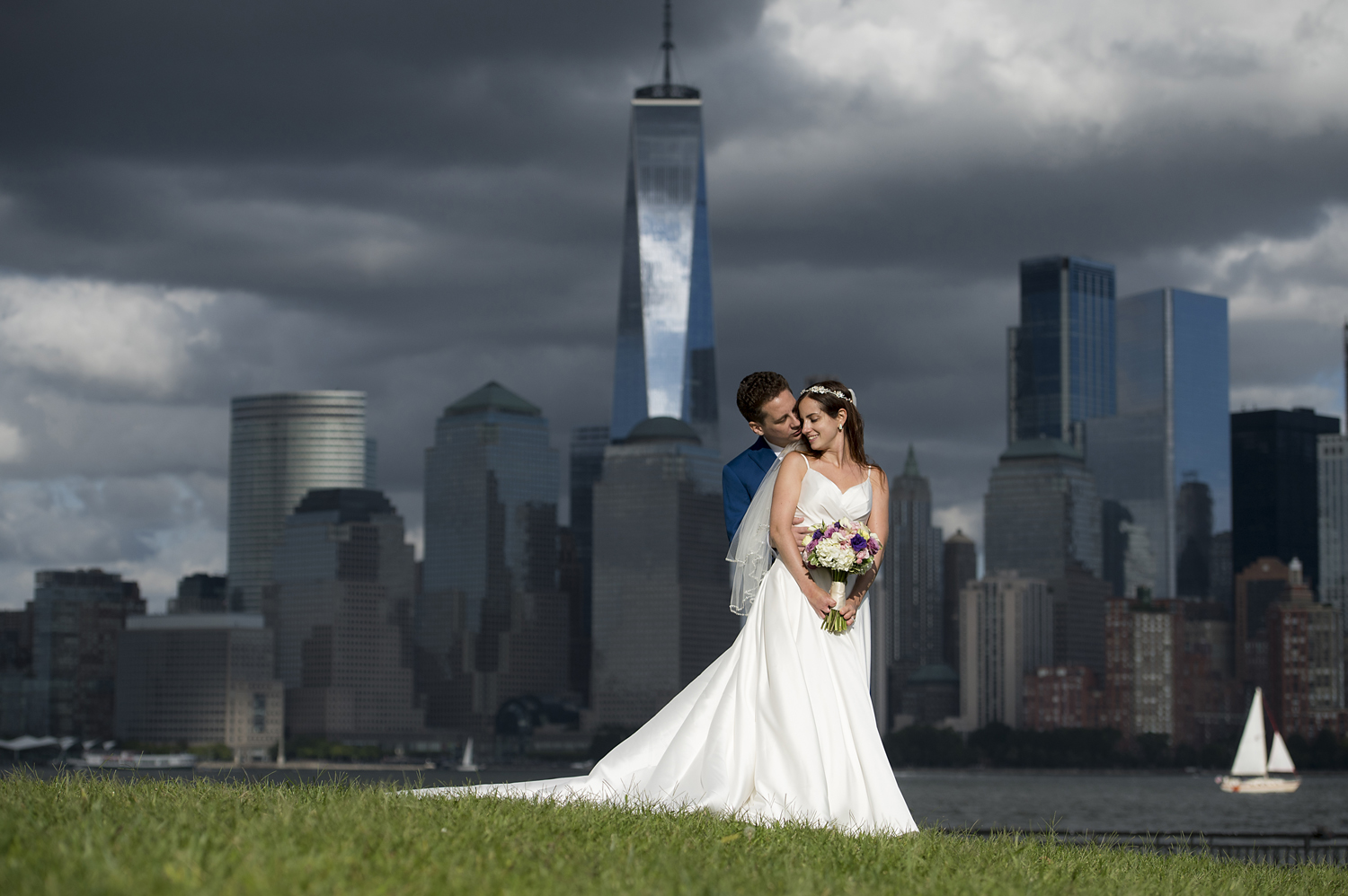bride and groom posing for a portrait againt the NYC skyline before their micowedding ceremony at Liberty House in Jersey City. Jersey City wedding photographer