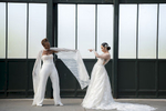 Brides pose for portraits at Liberty State Park before their Liberty House wedding in Jersey City