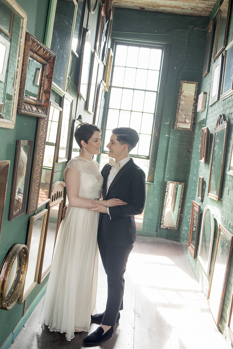 brides in green mirrored hallway at The Metropolitan Building. NYC Lesbian wedding