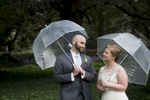 bride and groom with umbrellas on wedding day at Palmer House, Princeton. Princeton wedding photographer