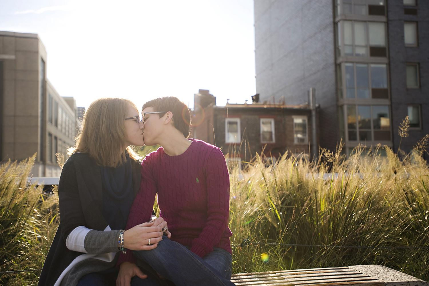 portrait of lesbian women kissing on The High Line during their engagement session Gay-friendly NJ wedding photographers