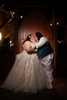 two bride kissing in front of red doors at Stone House at Stirling Ridge
