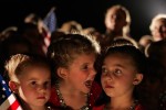 These young Kerry supporters from Zanesville, Ohio wore their sparkly dance costumes to a late-night campaign event on July 31, 2004. The eldest had opinions about how best to stand. 