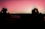 3/22/2005 -- Boston, MA -- The Esplanade -- Lovers kiss at sunset on the Esplanade in Boston, MA on Tuesday evening, March 22, 2005. For Magazine back cover. Photo by Dina Rudick, Boston Globe Staff. DO NOT ALTER THE COLORS OF THIS PHOTOGRAPH IN PRODUCTION!! IT IS SHOT ON CHROME FILM AND WAS CROSS-PROCESSED...THEREFORE THE INTENSE COLOR SHIFT AND SATURATION.