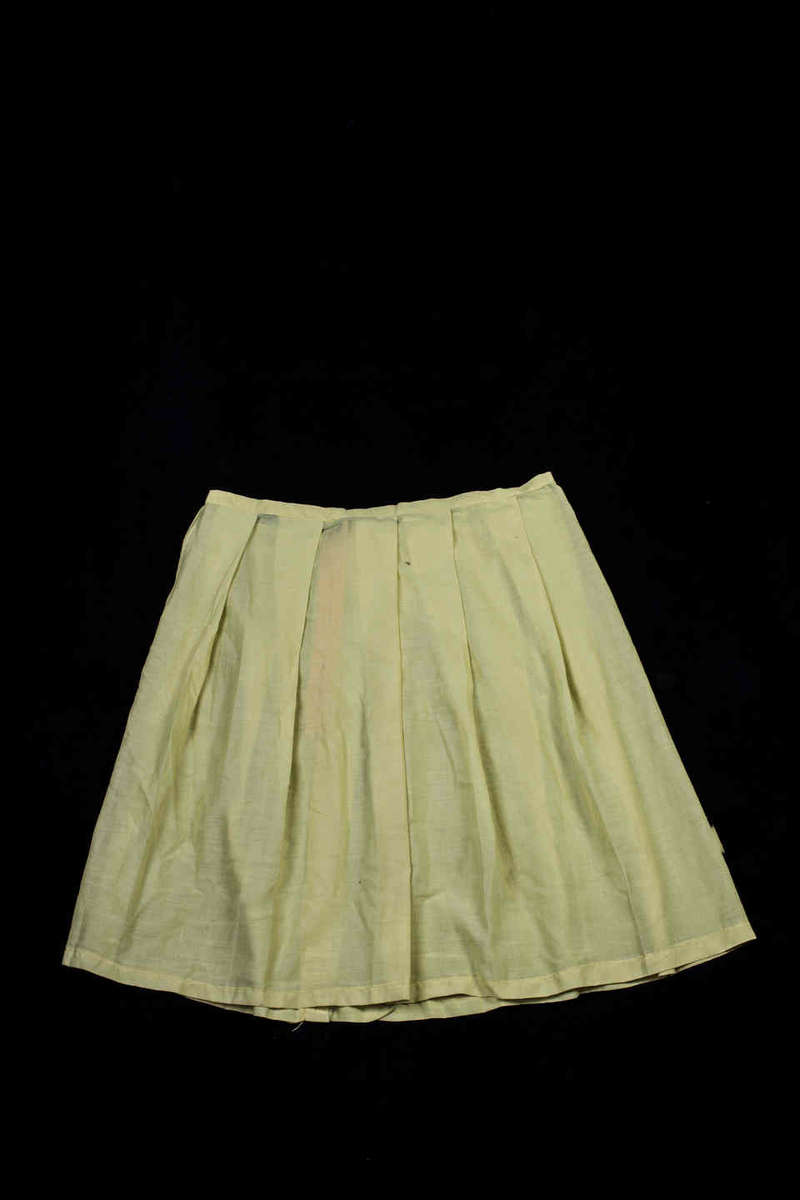 The skirt from Monica Enoch's sports uniform from Chibok Government School Monica, 18, loves singing. Her father is a pastor. Her friend Saratu escaped an attack from Gambaru, another village nearby, but lost her family and came to live with the Pastor Enoch and Monica. Both girls were among the  more than 200 girls who were kidnapped from a school in Chibok in Borno State on April 15 by Boko Haram, a terrorist group in northern Nigeria. Schools in the area had been shut down to due to Boko Haram attacks, but the girls had returned to sit their final exams.