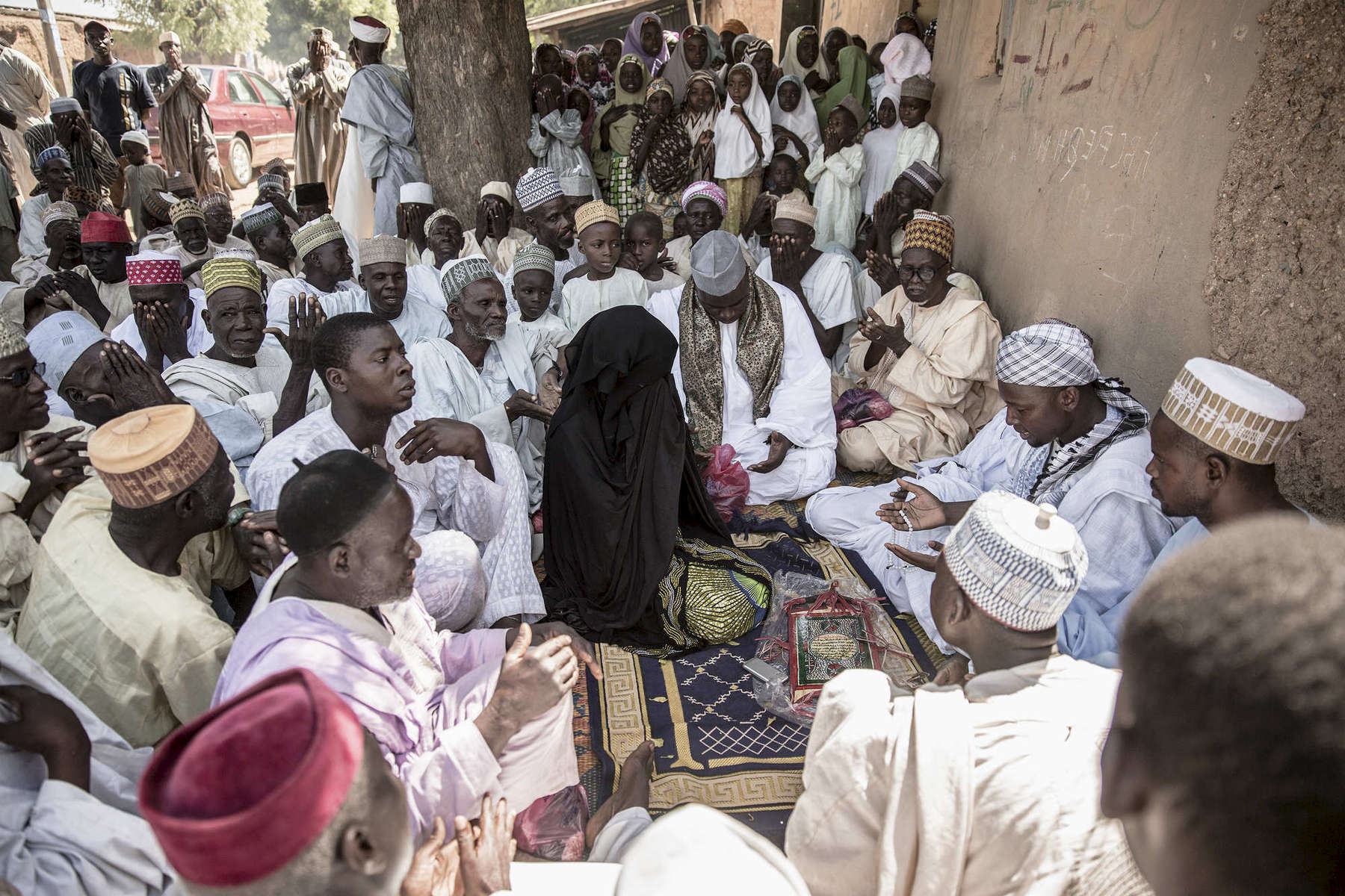 The wedding Fatiah, or ceremony, of Maryan Nazifi, in Dawakin Tofa, another small town outside of Kano, Northern Nigeria. Girls like Maryan rarely interact with men other than their relatives so to sit in front of all of the men of her village and receive their blessings is a moment of contract and prayer. 