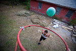 Jordan Anduja plays basketball in his uncle's front yard on the Pine Ridge Reservation in Pine Ridge, South Dakota on Tuesday, July 28, 2009. 