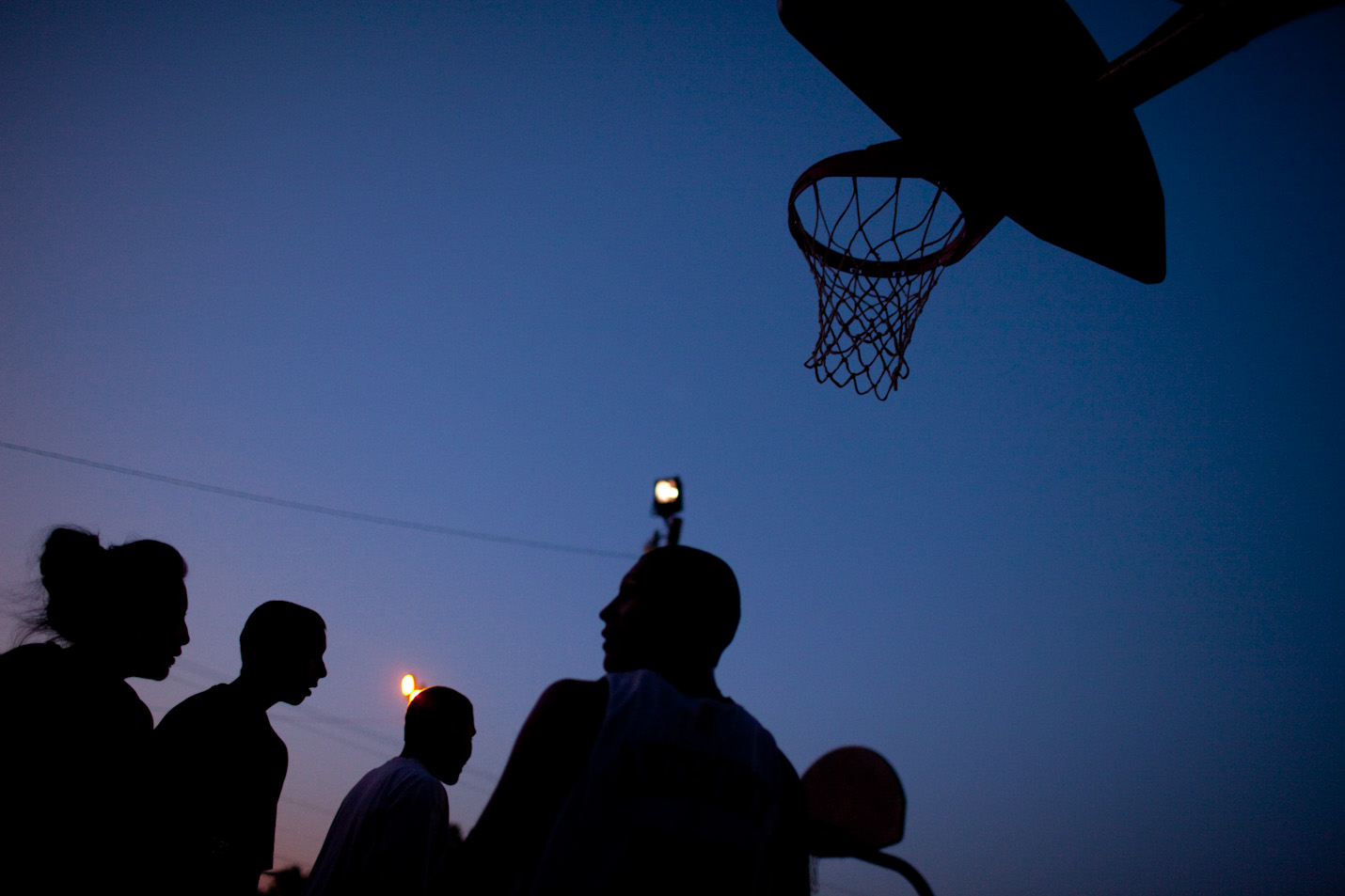 Basketball passes the time on a hot summer night on Pine Ridge Reservation, South Dakota.