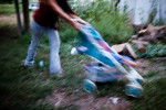 Alexis Oxendine pushes a stroller through the front yard in Pine Ridge, South Dakota.  Many houses lack basic amenities such as running water and electricity. 