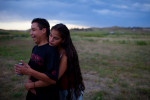 Rich Lone Elk, 24, a member of the North Side Tre Tre Gangsta' Crips, hugs one of his girlfriends, Alexis Oxendine at their house in Pine Ridge, South Dakota.  (Photo by Matthew Williams/ZUMA Press)