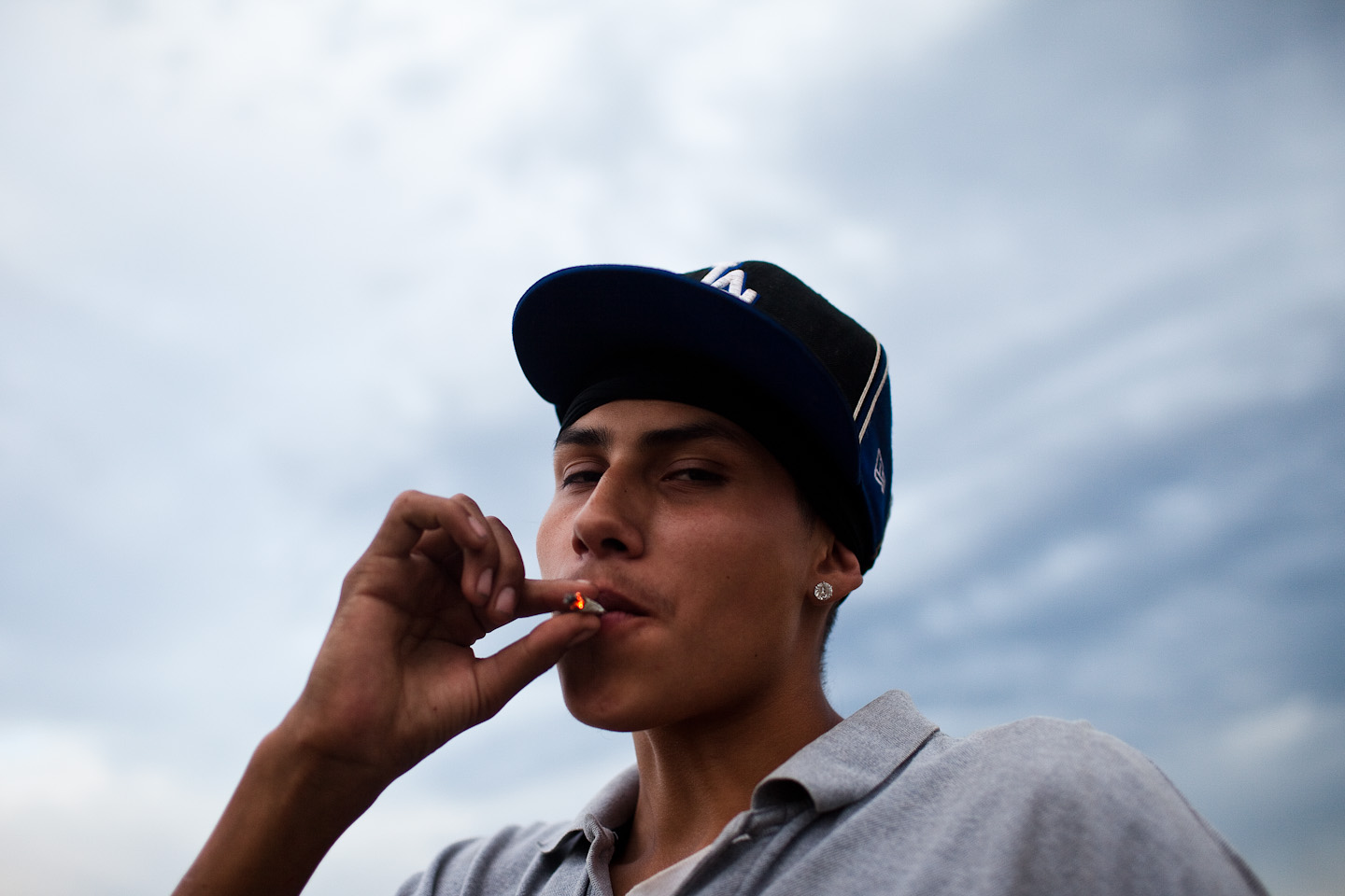 Richard {quote}Junior{quote} Lame smokes a joint on a summer night in Pine Ridge, South Dakota.  Many young people turn to drugs, alcohol, and gang violence at an early age. 