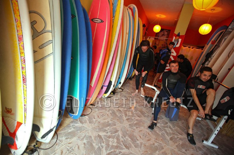 The guys suit up for a team building surfing lesson