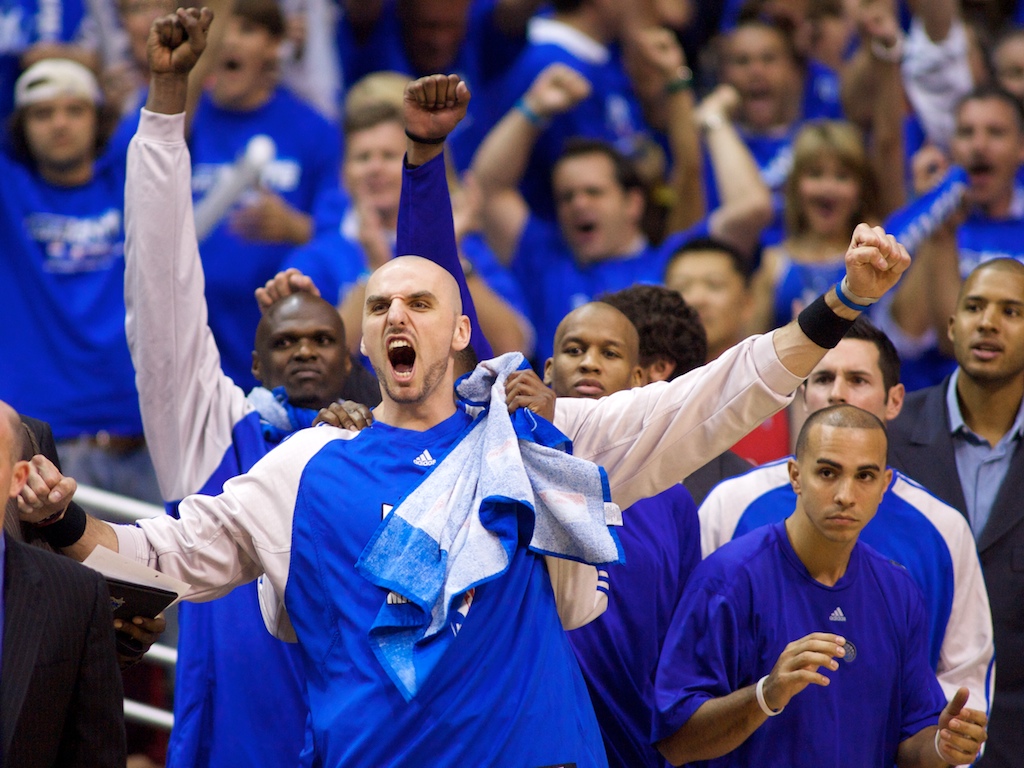 Orlando Magic center Marcin Gortat raises his arms in celebration during the final minutes of Game Five of the NBA Playoffs at the Amway Arena.