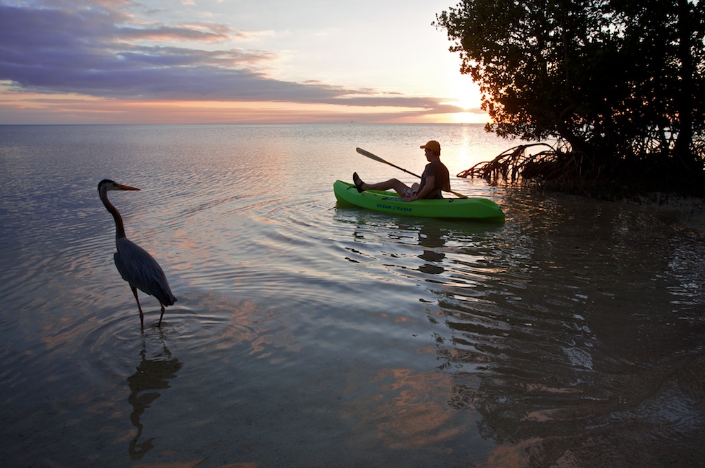 Christopher Collier paddles a kayak around Little Palm Island at sunset off the coast of Little Torch Key, FL.