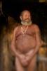 Local celebrity {quote}Naked{quote} Ed Watts poses for his portrait under the front porch of his shack. Watts who is a squater along the Sante Fe River in North Florida, chooses to live without many luxuries along with clothes.