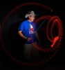 Lucky Meisenheimer poses for a portrait while demonstrating a trick with a light-up yo-yo during a time-lapse photo during a welcoming party for yo-yo competitors. 