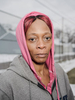 Sherry Joy stops for a portrait on her way to collect her daily allowance of one case of bottled water from Fire House #3, Martin Luther King Avenue, Flint, Michigan, January 27, 2016.