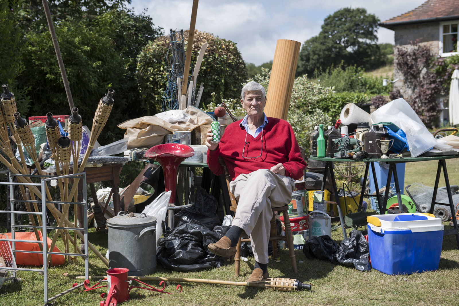 Portrait of D (John Wiseman) infron of the contents of his shed in the midst of cleaning and organizing his shed after 20 years. Visit to parents in  Thakeston, Somerset, UK