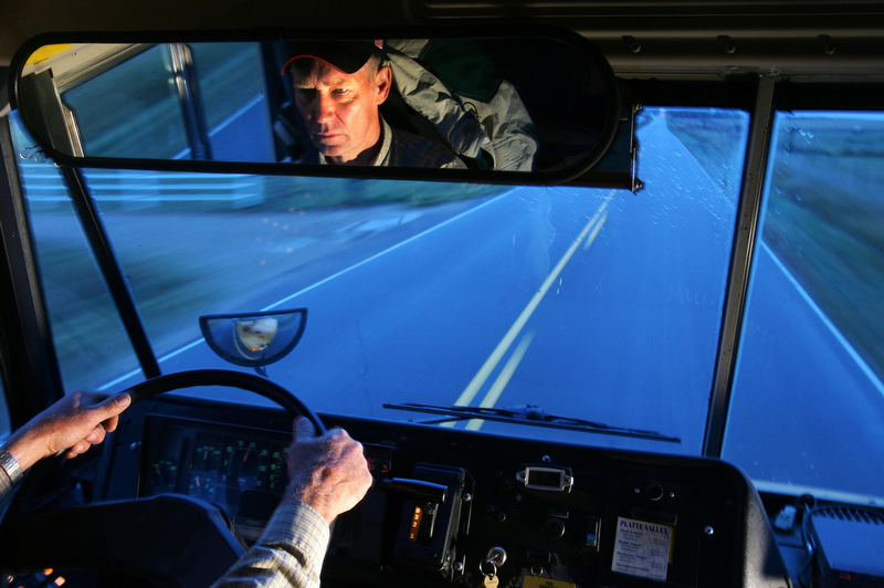 Glen Ford guides his school bus along a two-lane road south of Kersey. The middle of three Ford brothers whose bus was hit by a train on Dec. 14, 1961, Glen spent years on the rodeo circuit. Then, in 1984, he took a job driving a school bus in the same area where the crash occurred.