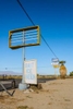 Two dilapidated roadside tall business signs with their main signage broken and missing along California highway 111 by Bombay Beach near the Salton Sea in Southern California.