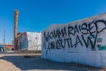 Momma raised an outlaw graffiti spray painted on a building, a mobile home, in the settlement of Bombay Beach, California near the Salton Sea.