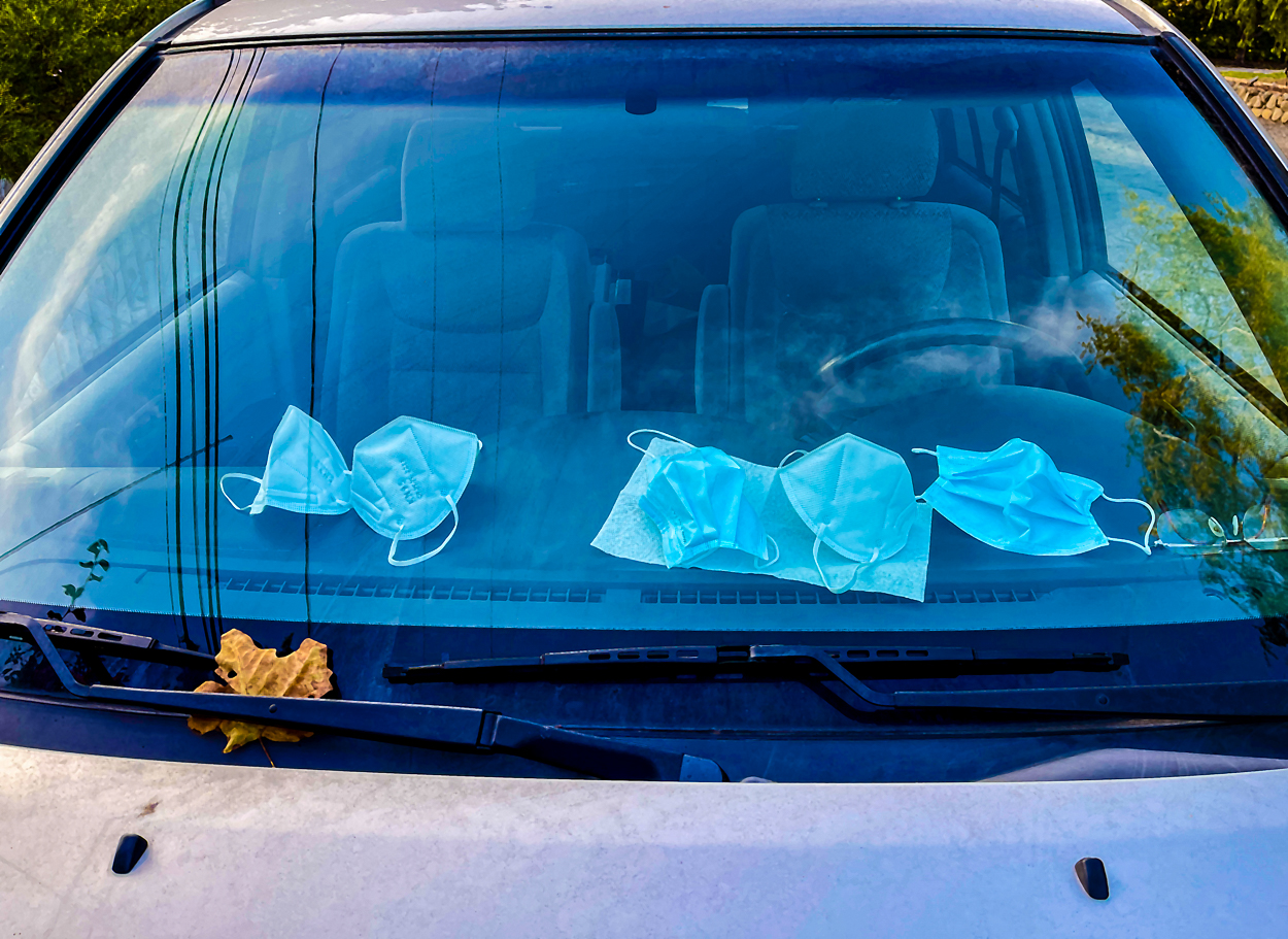 Multiple face masks on dashboard in Santa Barbara County during the height of the COVID-19 pandemic.