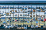 Many lover's padlocks and other locks are locked to the fence overlooking the deep canyon at the Butte Creek Watershed Overlook in Paradise, California.