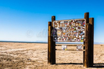 Sign for Salton Sea Recreational Area covered with stickers to make it almost unreadable.