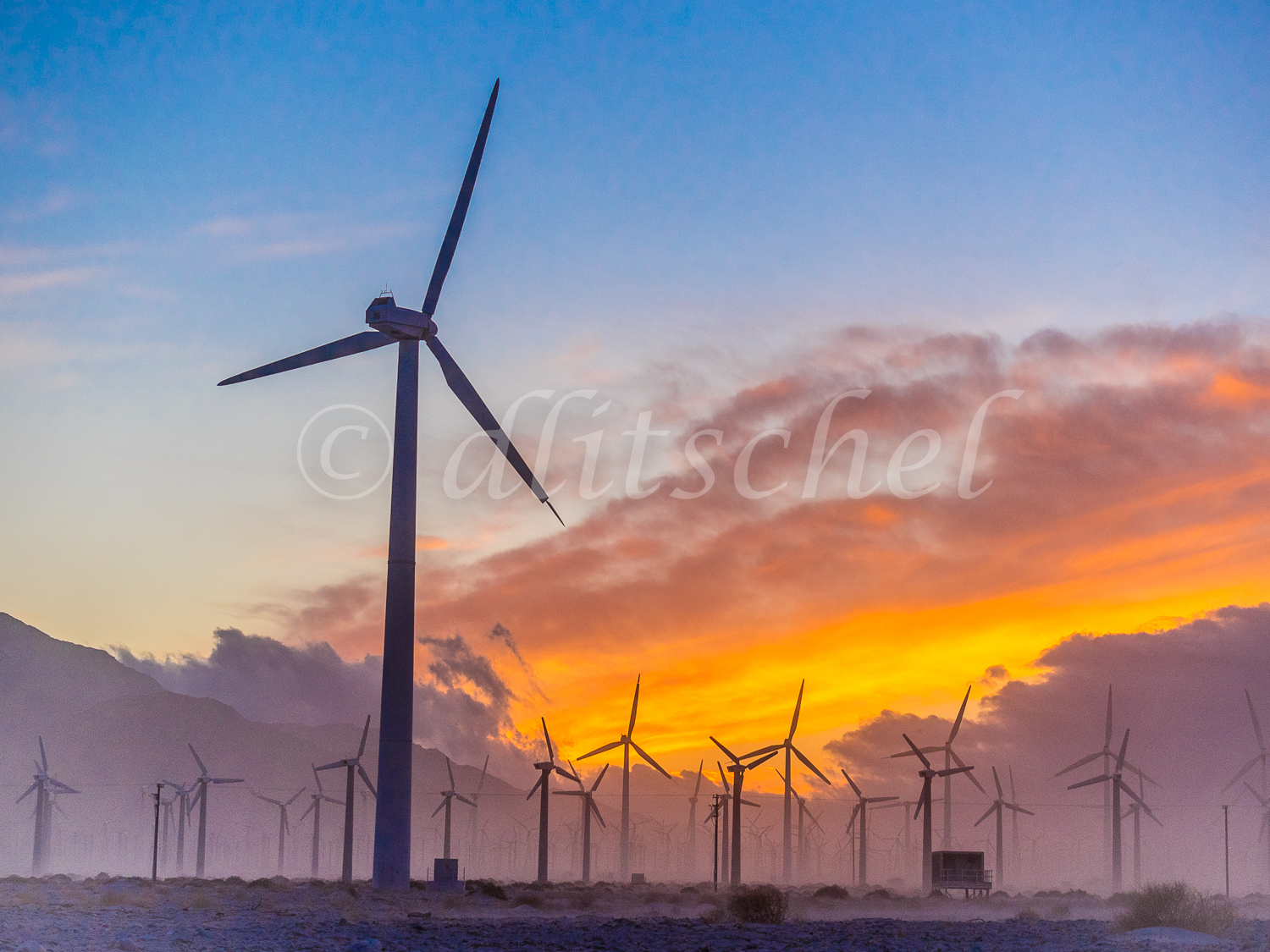 A wind farm outside of Palm Springs, California during a colorful sunset. A wind turbine is a device that converts kinetic energy from the wind into electrical power. The term appears to have migrated from parallel hydroelectric technology (rotary propeller). The technical description for this type of machine is an aerofoil-powered generator.The result of over a millennium of windmill development and modern engineering, today's wind turbines are manufactured in a wide range of vertical and horizontal axis types. The smallest turbines are used for applications such as battery charging for auxiliary power for boats or caravans or to power traffic warning signs. Slightly larger turbines can be used for making contributions to a domestic power supply while selling unused power back to the utility supplier via the electrical grid. Arrays of large turbines, known as wind farms, are becoming an increasingly important source of renewable energy and are used by many countries as part of a strategy to reduce their reliance on fossil fuels.